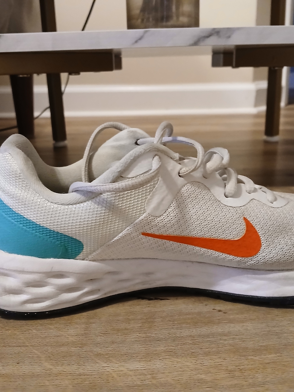 Nike Women's White Sneakers with Orange Swoosh and Teal Heel Accent